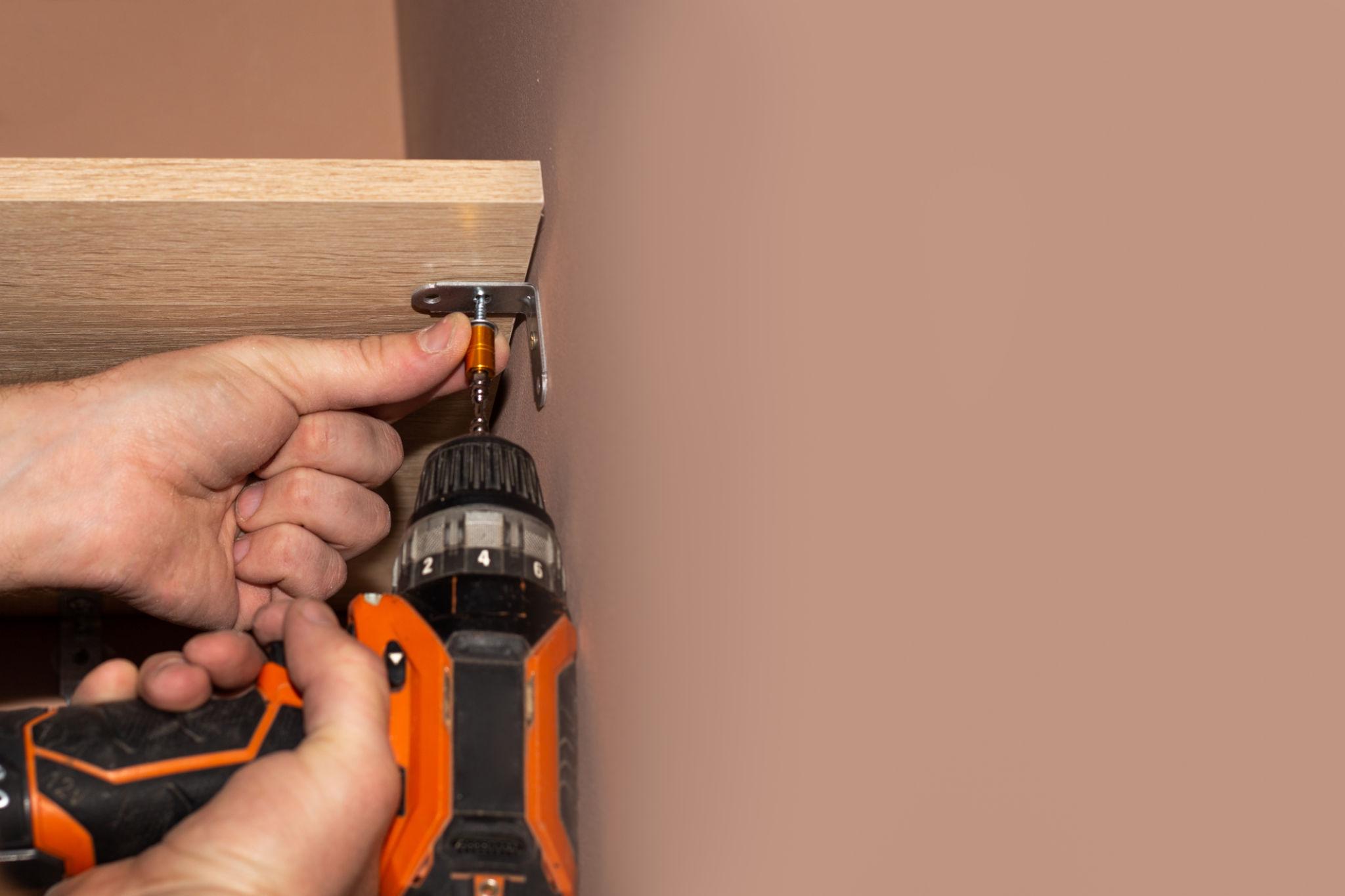 Home maintenance and cleaning work near a window